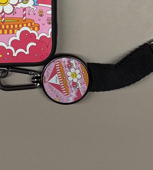 A printed charm on a phone strap.